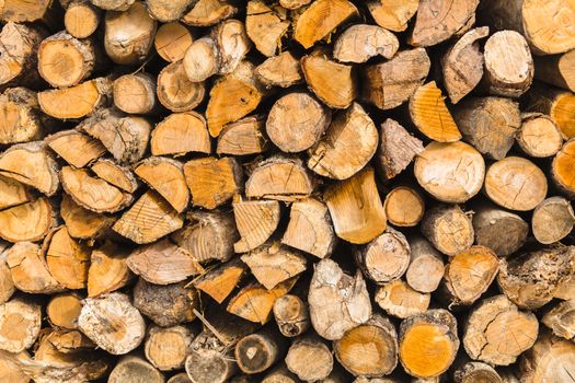 detail of pile of natural wooden logs texture background