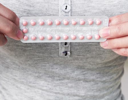 Close up hand hold birth-control pill for health care and medicine concept