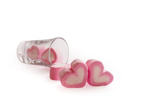 Marshmallow pink heart shape in glass on white background