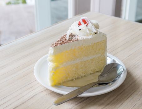 Closeup Milk cake delicious on the wood table from coffee and bakery shop, selective focus