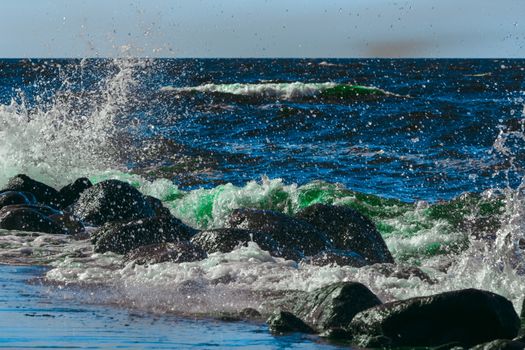 Summer ocean beach with green waves at sunny day