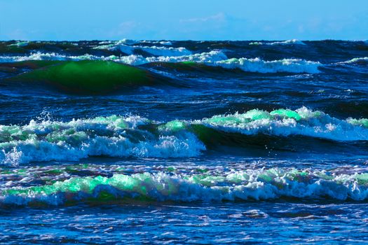 Summer ocean beach with green waves at sunny day