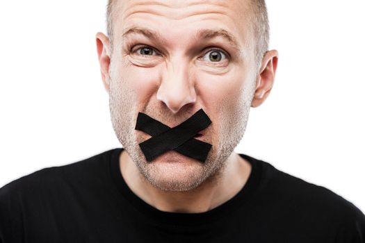 Forbidden word or speech censorship concept - scared adult man adhesive tape closed mouth white isolated