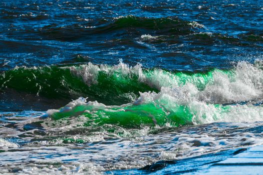 Summer ocean beach with green waves at sunny day