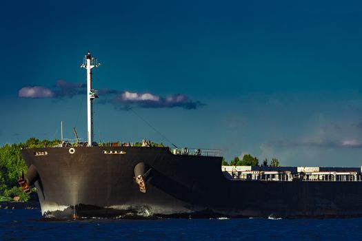 Black bulk carrier moving at evening to Baltic sea