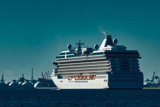 White cruise ship sailing from Baltic sea at evening