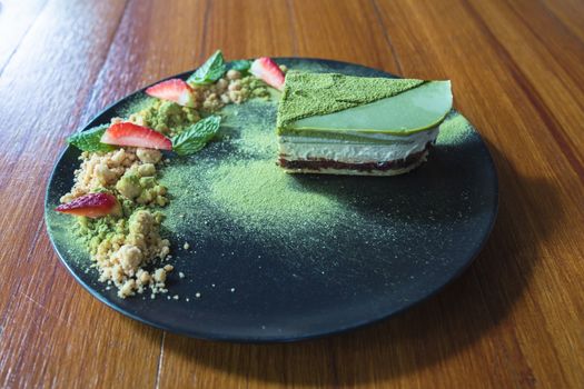 Matcha green tea ice cream cake with strawberry and cookie crumble