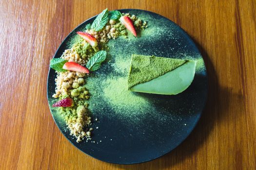 Matcha green tea ice cream cake with strawberry and cookie crumble