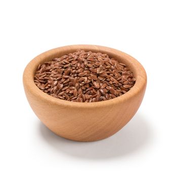 Ground or crushed brown flax seed or linseed in a wooden bowl, isolated on white