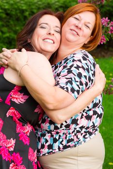 two woman in their forties hugging