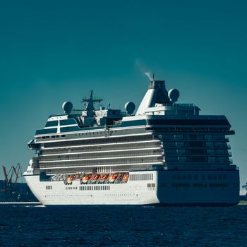 White cruise ship sailing from Baltic sea at evening