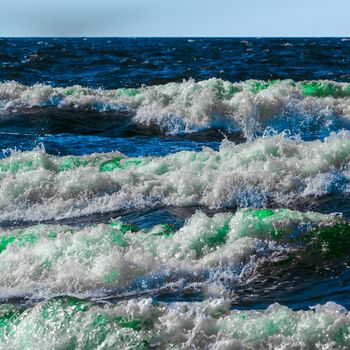 Summer ocean beach with green waves at sunny day