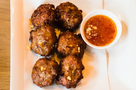 Deep fried pork meatballs with spicy sauce