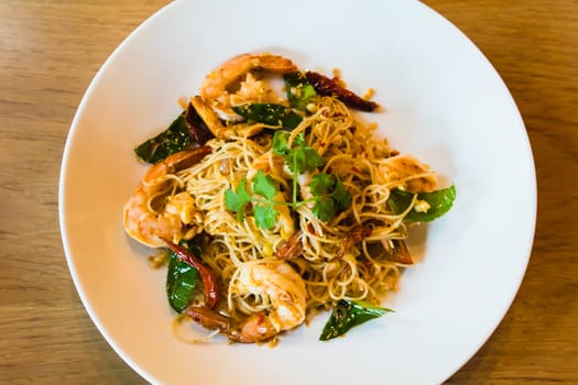 Spicy stir fried spaghetti seafood on white dish