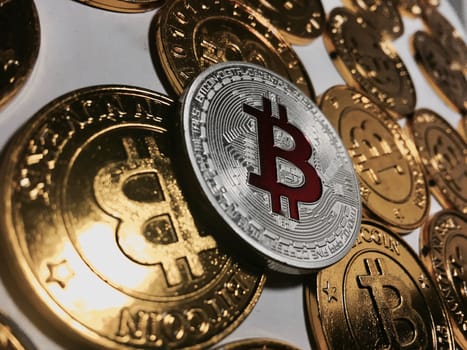 Digital currency physical metal bitcoin coin on the gold bitcoins. Cryptocurrency concept.
