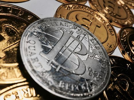 Digital currency physical metal bitcoin coin on the gold bitcoins. Cryptocurrency concept.