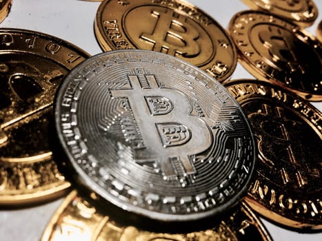 Digital currency physical metal bitcoin coin on the gold bitcoins. Cryptocurrency concept.