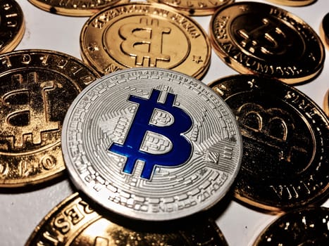 Digital currency physical metal bitcoin coin on the gold bitcoins. Cryptocurrency concept.