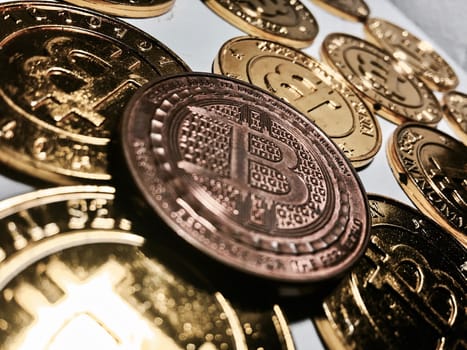 Digital currency physical metal bitcoin coin on the gold bitcoins. Cryptocurrency concept.