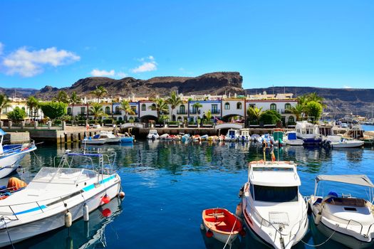 Port and promenade of beautiful romantic picturesque village Puerto de Mogan on Gran Canaria.