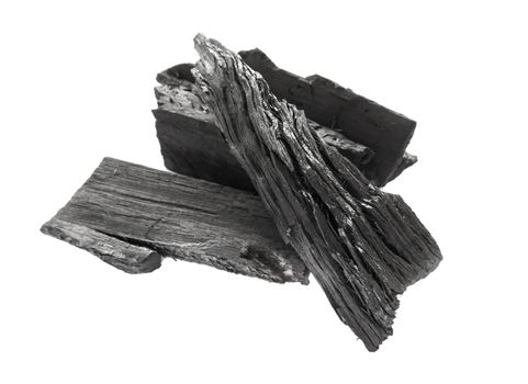 Closeup black charcoal on white background, raw material for make cooking