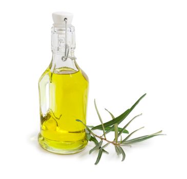 Small glass bottle of olive oil with lockable lid and olive branch beside on a white background

