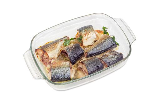 Baked pieces of Atlantic chub mackerel in the rectangular glass pan for baking on a white background
