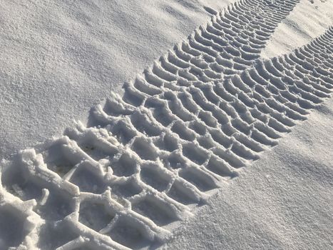 traces of the land vehicle on the snow