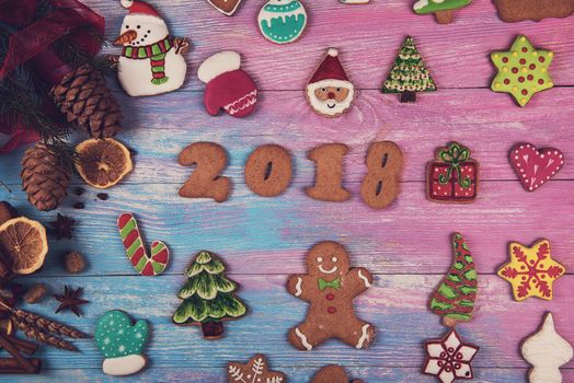 Gingerbreads for new 2018 year on wooden background, xmas theme