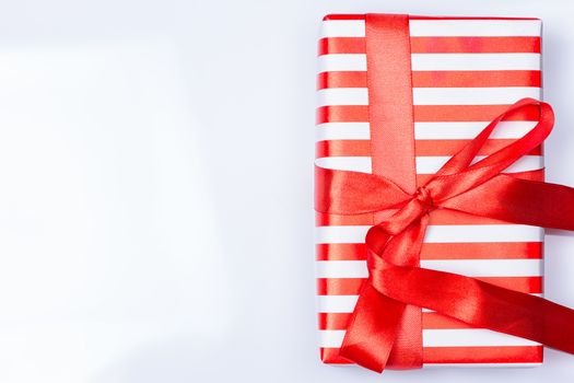Red gift box with ribbon on white
