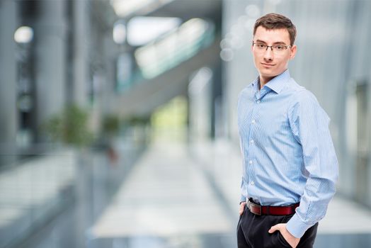 25 year old entrepreneur in blue shirt in office