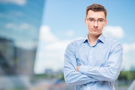 Businessman in glasses young and very successful, in office