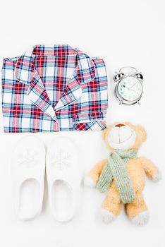 baby pajamas and toy for good dreams, top view on a white background