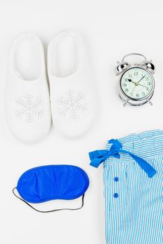 objects with a slipper and pajama objects view from above on a white background