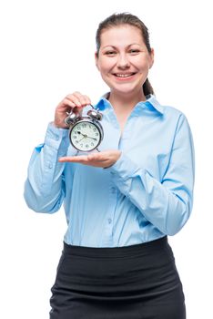 Vertical portrait of businesswoman in blue shirt with alarm clock on white background