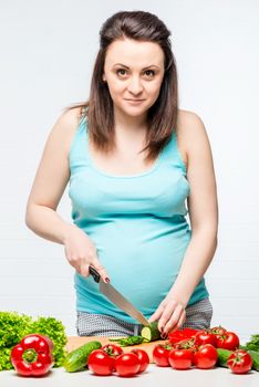 pregnant girl preparing from fresh healthy vegetable salad