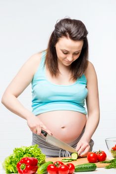 young pregnant brunette preparing healthy food