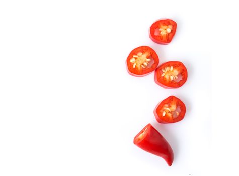 Closeup top view red chili pepper with sliced on white background, raw food ingredient concept