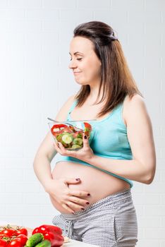 Satisfied woman eats a delicious vegetable salad