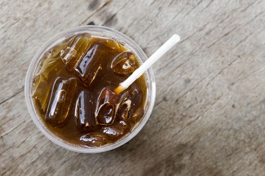 Close up ice of americano or black coffee on wood background