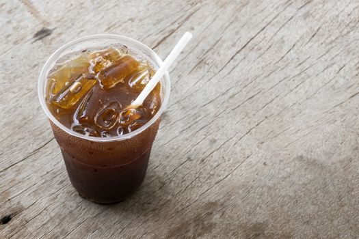 Close up ice of americano or black coffee on wood background