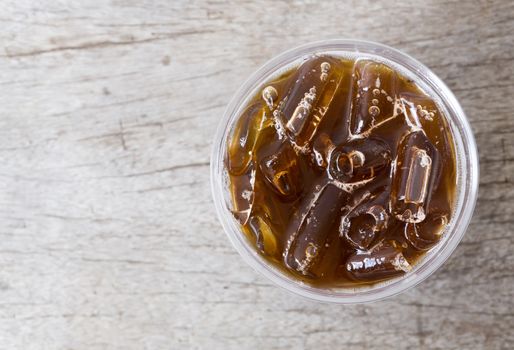 Close up top view ice of americano or black coffee on wood background