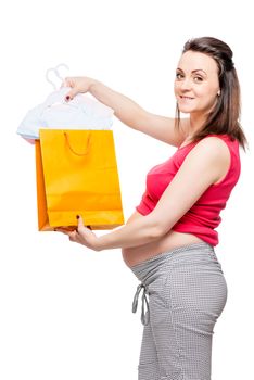 happy pregnant woman showing purchases for future baby isolated