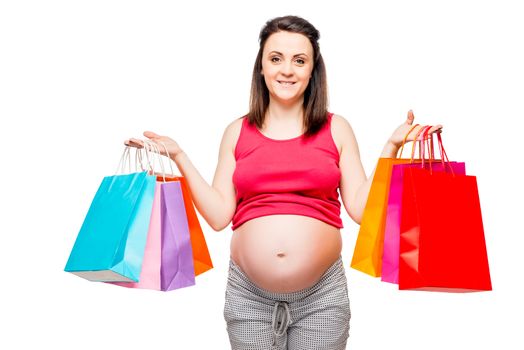 Portrait of a happy and beautiful future mother with shopping on a white background