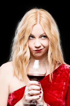 portrait of a blonde in a red dress with a glass of wine on a black background