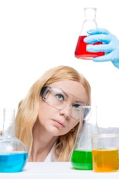 The chemist in glasses analyzes a liquid in test tubes is isolated