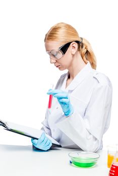 vertical portrait of an experienced chemist with test tubes and a folder