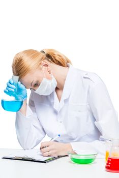 weary chemist records the result of tests in a notebook