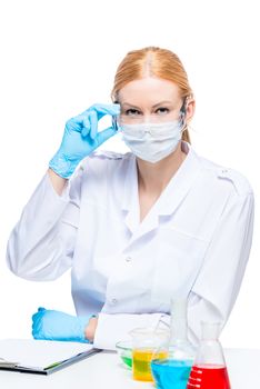 portrait of a young successful chemist in protective clothing in the laboratory