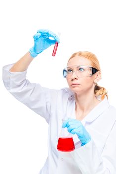 An experienced chemist examines the red substance in a test tube, makes experiments